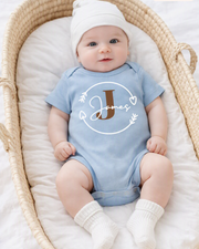 Baby wearing a blue onesie with name