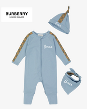 Burberry baby outfit set with onesie, hat, and bib on a white background