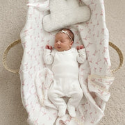 Newborn baby girl sleeping in a basket on a soft muslin blanket – Eli&Eli baby gifts Dubai