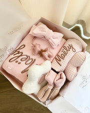 Set of baby booties and socks with 'Maeley' branding in a decorative box.