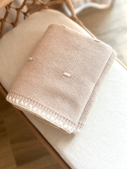 Knitted blanket on a chair with a blurred background