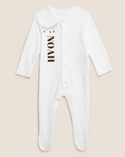 White baby cotton overall with gold stars and text pattern