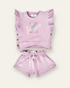 A set of lavender-colored kids' clothes, including a top with ruffles and shorts, with a personalized name 'Zaia' printed on the top.