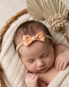 Tiny baby headband with silk bow in peach - Eli&Eli Dubai