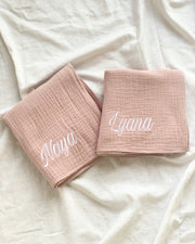 Muslin Swaddle plain  with embroidery name pink on a flatlay